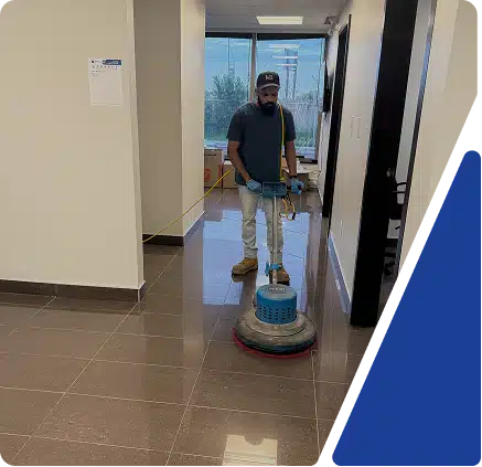 A cleaner mopping a polished hallway floor, framed by blue graphics.