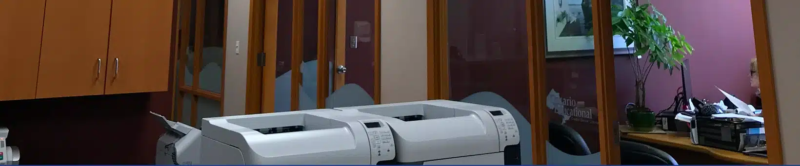 A close-up view of a printer or copier machine in an office setting.