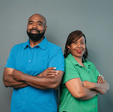 Portrait of a man in a bright blue shirt and a woman in a green shirt standing together.