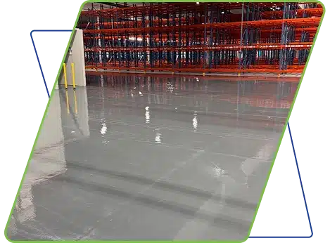 An empty warehouse interior with red metal shelving and a polished floor, framed by green and white graphics.