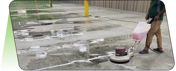 A wet concrete or paved outdoor surface with a yellow bollard.